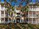 Inviting condo exterior with screened balconies, lush landscaping, and secure entrance in a tranquil community at 4802 51St W St # 1811, Bradenton, FL 34210