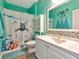 Bathroom with coastal themed shower curtain, mirror, and vanity at 4802 51St W St # 1811, Bradenton, FL 34210