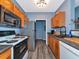 Galley kitchen featuring wood cabinets, sleek appliances, and hardwood floors at 4802 51St W St # 1811, Bradenton, FL 34210