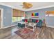 Inviting living room with blue sofa, patterned rug, neutral window shades and stylish accents at 4802 51St W St # 1811, Bradenton, FL 34210