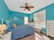 Bedroom with a ceiling fan, blue walls, wood floor and lots of natural light from the windows at 4802 51St W St # 1811, Bradenton, FL 34210