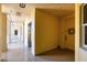 Hallway with elevator access features neutral decor, a wreath on the unit door, and natural light at 5531 Cannes Cir # 605, Sarasota, FL 34231