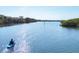 Scenic waterfront view with a person kayaking on calm waters, surrounded by lush greenery at 5531 Cannes Cir # 605, Sarasota, FL 34231