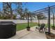 Outdoor patio area with BBQ, chairs, and a pergola overlooking the fenced backyard, perfect for relaxing and entertaining at 5809 71St E St, Palmetto, FL 34221