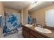 Well-lit bathroom featuring a double vanity, a turtle themed shower curtain, and ample counter space at 5809 71St E St, Palmetto, FL 34221