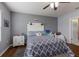 Bright bedroom features soft gray walls, wood floors, a ceiling fan, and a comfortable bed with a patterned quilt at 5809 71St E St, Palmetto, FL 34221