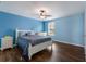 Serene blue bedroom with a white bed frame, matching nightstands, and gleaming hardwood floors at 5809 71St E St, Palmetto, FL 34221