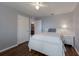 Bright bedroom with wood floors, a white bed, a matching nightstand, and access to the bathroom at 5809 71St E St, Palmetto, FL 34221