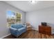Comfortable room with natural light, wood floors, and a blue couch near the window at 5809 71St E St, Palmetto, FL 34221