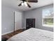 Inviting bedroom featuring wood floors, a ceiling fan, a large window, and a dark wood dresser at 5809 71St E St, Palmetto, FL 34221