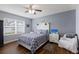 Comfortable bedroom with a ceiling fan, wood floors, and a well-lit window at 5809 71St E St, Palmetto, FL 34221