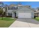 Attractive two-story home with a two-car garage, manicured lawn, and a modern architectural style at 5809 71St E St, Palmetto, FL 34221