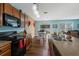 Modern kitchen with stainless steel appliances, granite countertops, and an open floor plan to the dining area at 5809 71St E St, Palmetto, FL 34221