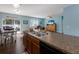 Bright, open floor plan with a view of a kitchen island and appliances at 5809 71St E St, Palmetto, FL 34221
