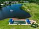 Overhead view of a community lake with a fountain and a lawn bowling area at 6524 Fairway Gardens Dr # 6524, Bradenton, FL 34203