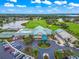 Stunning aerial view of a clubhouse with a golf course, lakes, and amenities under a bright blue sky at 6524 Fairway Gardens Dr # 6524, Bradenton, FL 34203