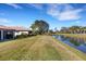Spacious backyard with mature trees and a pond is ideal for relaxation at 8079 36Th Street E Cir, Sarasota, FL 34243