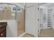 Bathroom featuring tiled shower with glass door and a walk-in closet at 8079 36Th Street E Cir, Sarasota, FL 34243
