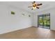 Bright bedroom featuring a ceiling fan, natural light, and a sliding glass door at 8079 36Th Street E Cir, Sarasota, FL 34243