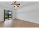 Bright bedroom with tray ceilings and a sliding glass door to a patio at 8079 36Th Street E Cir, Sarasota, FL 34243
