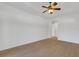 Bedroom with tray ceilings, neutral paint, and hardwood floors at 8079 36Th Street E Cir, Sarasota, FL 34243