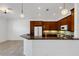 Well-lit kitchen featuring dark wood cabinets, granite countertops, and modern lighting at 8079 36Th Street E Cir, Sarasota, FL 34243