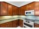 Close-up of the kitchen area showcasing the granite countertops, and appliances at 8079 36Th Street E Cir, Sarasota, FL 34243