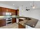 Well-lit kitchen features stainless steel appliances, granite countertops, and stylish cabinetry at 8079 36Th Street E Cir, Sarasota, FL 34243