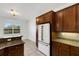 Kitchen featuring modern appliances, granite countertops, and wood cabinets at 8079 36Th Street E Cir, Sarasota, FL 34243