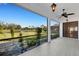 Spacious screened-in lanai showcasing a peaceful backyard with a serene pond view perfect for relaxing and entertaining at 8079 36Th Street E Cir, Sarasota, FL 34243