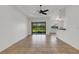 Bright living room featuring tile floors, natural light, and a ceiling fan at 8079 36Th Street E Cir, Sarasota, FL 34243