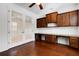 Well-lit home office with a built-in desk, cabinetry, and French doors at 8079 36Th Street E Cir, Sarasota, FL 34243