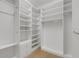Spacious walk-in closet with custom shelving and drawers for optimal organization and clothing storage at 8079 36Th Street E Cir, Sarasota, FL 34243