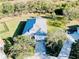 Aerial view of the home showcasing mature landscaping, a spacious driveway, and a two-car garage at 8134 Coates Row Pl, Bradenton, FL 34201