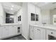 Bright bathroom with dual sinks, large mirrors, and a walk-in shower at 8134 Coates Row Pl, Bradenton, FL 34201