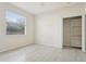 Bright bedroom with tile floors, large window, and closet with shelving at 8134 Coates Row Pl, Bradenton, FL 34201