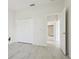 Bright and airy bedroom featuring tile floors, a closet, and an open doorway at 8134 Coates Row Pl, Bradenton, FL 34201