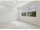 Bright bedroom with tile floors and a window overlooking the backyard at 8134 Coates Row Pl, Bradenton, FL 34201