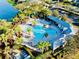 Aerial view of community pool, playground, and landscaping near a lake at 8134 Coates Row Pl, Bradenton, FL 34201