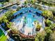 Overhead shot of a community pool with palm trees, water features, and comfortable lounge seating at 8134 Coates Row Pl, Bradenton, FL 34201