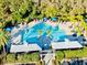 Aerial view of community pool with multiple seating areas, lounge chairs and shady spots at 8134 Coates Row Pl, Bradenton, FL 34201
