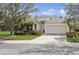 Charming one-story home featuring a manicured lawn, mature landscaping, and a two-car garage at 8134 Coates Row Pl, Bradenton, FL 34201