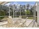 Screened-in patio with a table and chairs, perfect for outdoor dining at 8134 Coates Row Pl, Bradenton, FL 34201