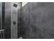 Modern shower with gray tiles, a rainfall showerhead, and handheld sprayer at 8134 Coates Row Pl, Bradenton, FL 34201