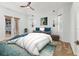 Bright bedroom with a ceiling fan, ensuite bath, and natural light at 907 Garland Ave, Nokomis, FL 34275