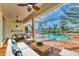 Outdoor pool area with a screened enclosure, dining and plenty of seating at 907 Garland Ave, Nokomis, FL 34275