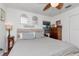 Bedroom features a queen bed with wood accents, neutral bedding, and two windows at 1206 2Nd E Ave, Bradenton, FL 34208