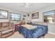 Bedroom features a queen bed, accent chair, and two windows at 1206 2Nd E Ave, Bradenton, FL 34208