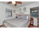 Bedroom features a queen bed with wood accents, neutral bedding, and two windows at 1206 2Nd E Ave, Bradenton, FL 34208