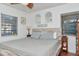 Bedroom features a queen bed with wood accents, neutral bedding, and natural light at 1206 2Nd E Ave, Bradenton, FL 34208